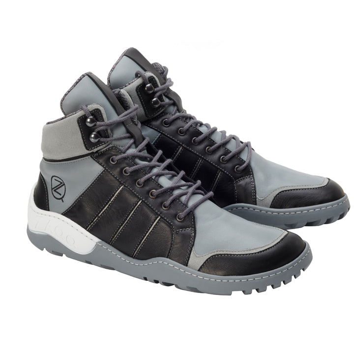 Wir präsentieren den Q2 Grey Waterproof von ZAQQ: Diese High-Top-Sneakers bestechen durch ihr modernes Design und eignen sich daher perfekt als Outdoorschuh. Sie verfügen über graue und schwarze Schnürsenkel, gepolsterte Kragen und markante Nähte. Das Logo der Marke ziert die Seiten, während die ZAQQ TERRA Sohle für Stabilität auf strukturierten Oberflächen sorgt.